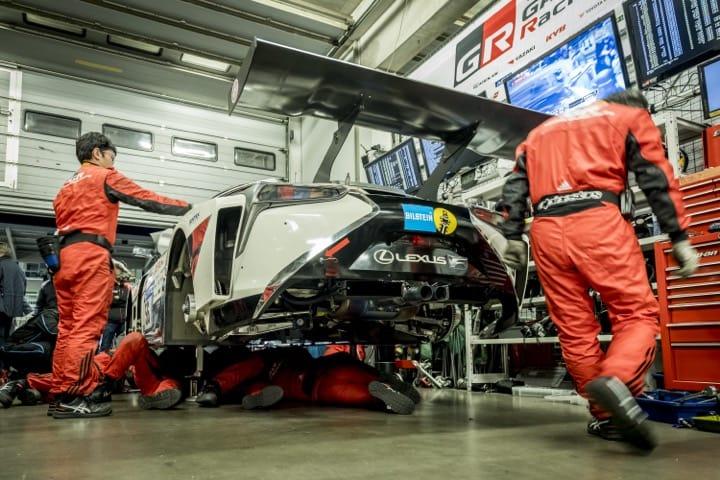 Mechanics adjusting the machine in the pit of the circuit